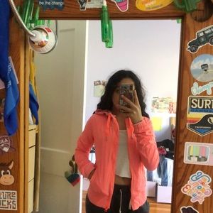 bright pinkish-orange lululemon jacket.